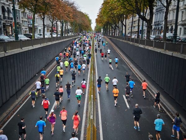 people running on road during daytime